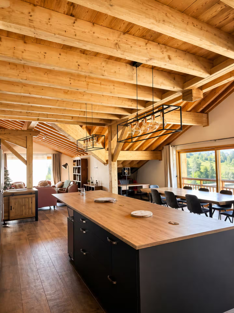 The two large dining tables in the living area, seating fourteen
